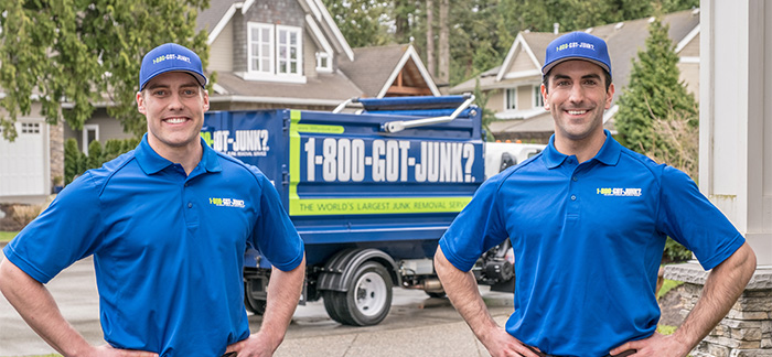 Two 1-800-GOT-JUNK? Truck Team Members ready to clean up and dispse of an old tub.