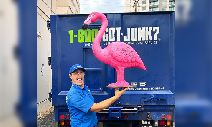 A 1-800-GOT-JUNK? Truck Team Member with a pink flamingo